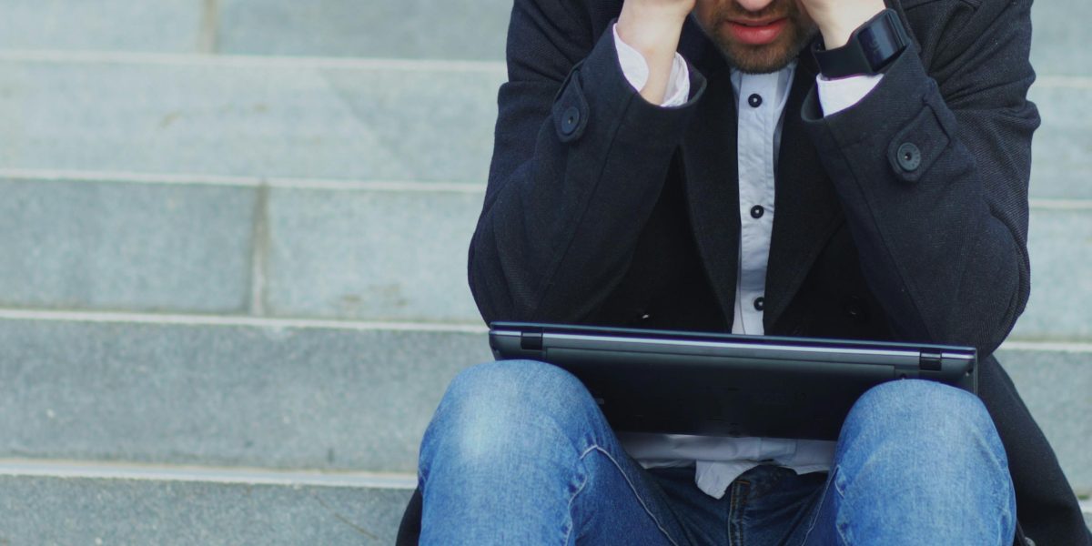 A person feeling overwhelmed while searching for a rental property, reflecting the common tenant experience.
