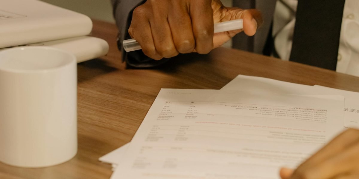 A person carefully reviewing terms and conditions of a lease agreement.