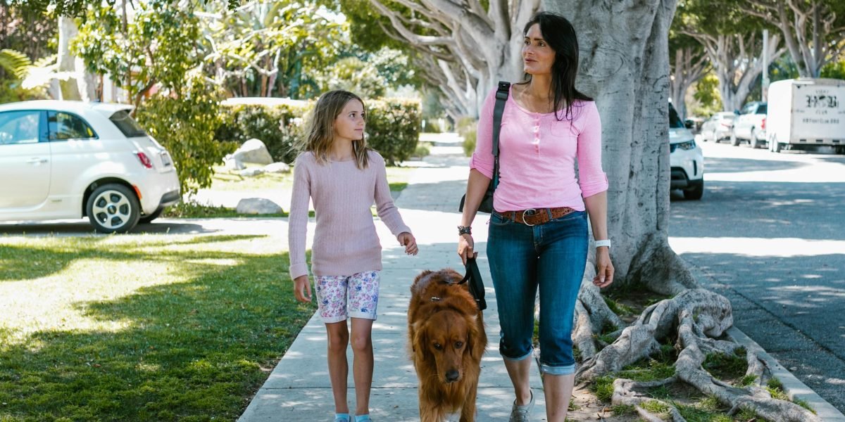 A family walking together in a pleasant neighborhood, exploring amenities like parks and local shops.