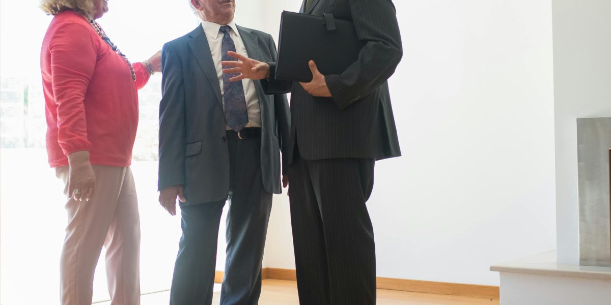 A real estate agent attentively listening to a client in a professional setting, emphasizing personalized service.