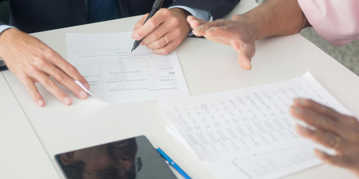 A client reviewing a rental contract with a professional advisor, emphasizing clear understanding of legal documents.