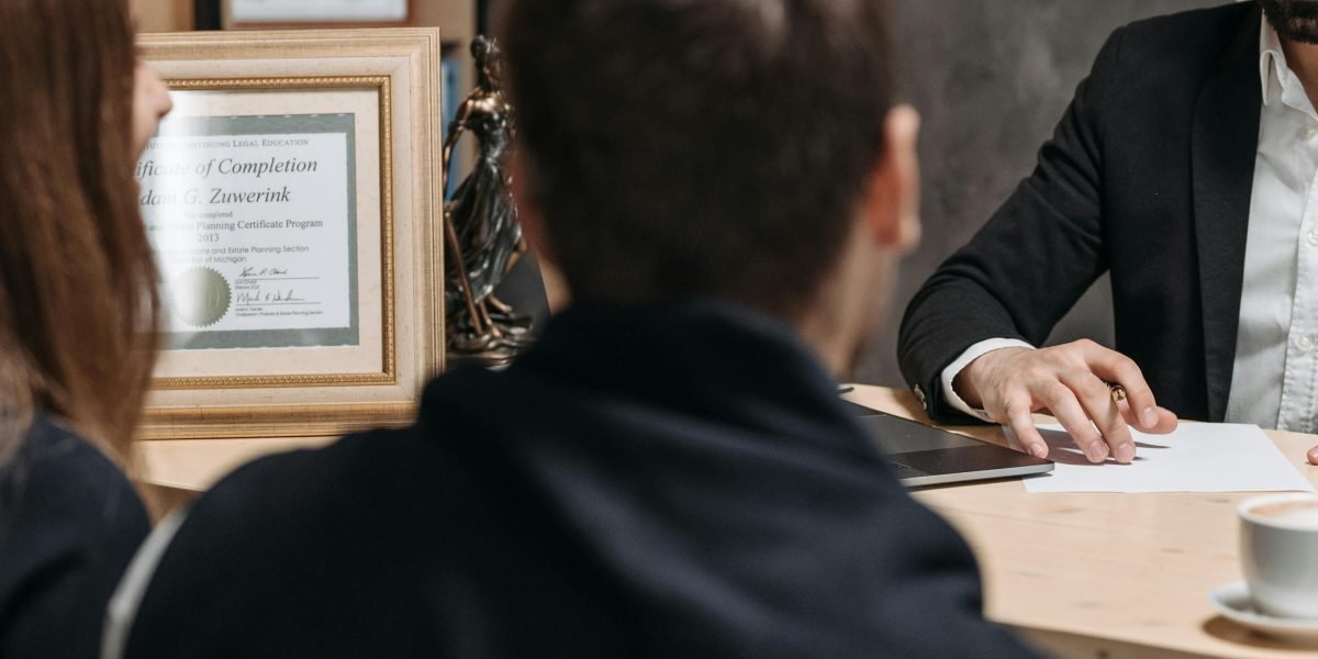 Two professionals engage in a focused discussion, representing a renter consulting with a reputable property dealer about their needs.