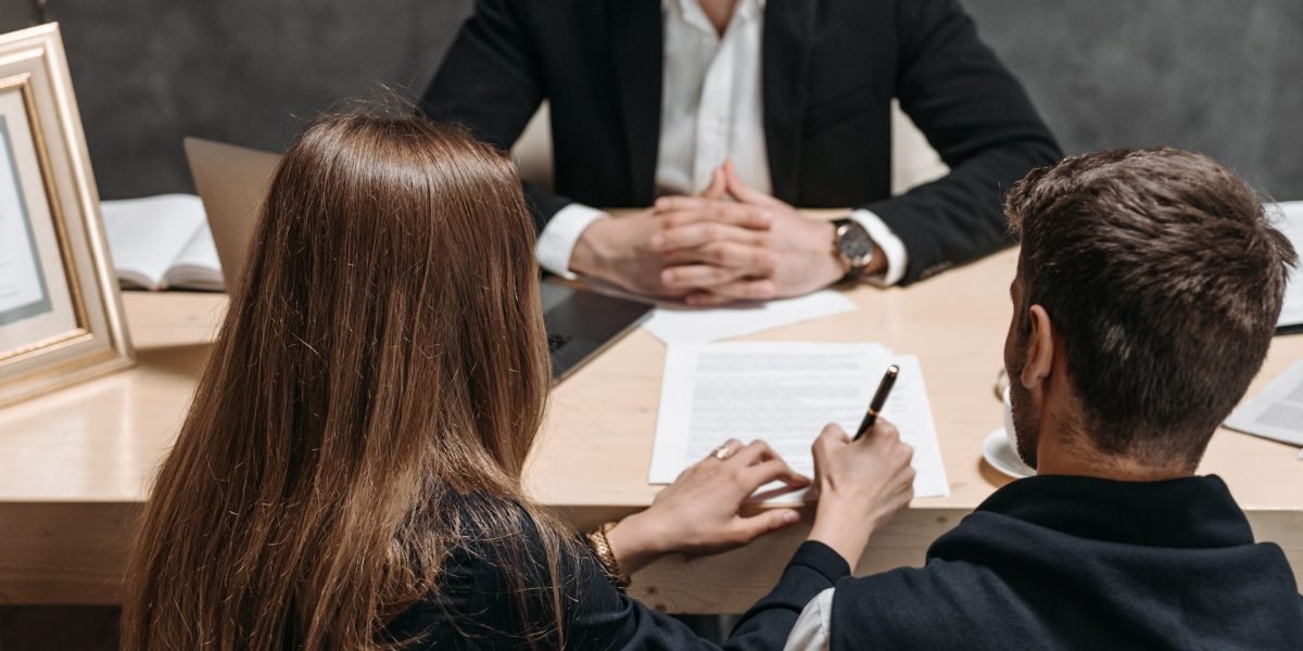 Individuals engaged in a discussion, demonstrating negotiation tactics to secure a better deal.